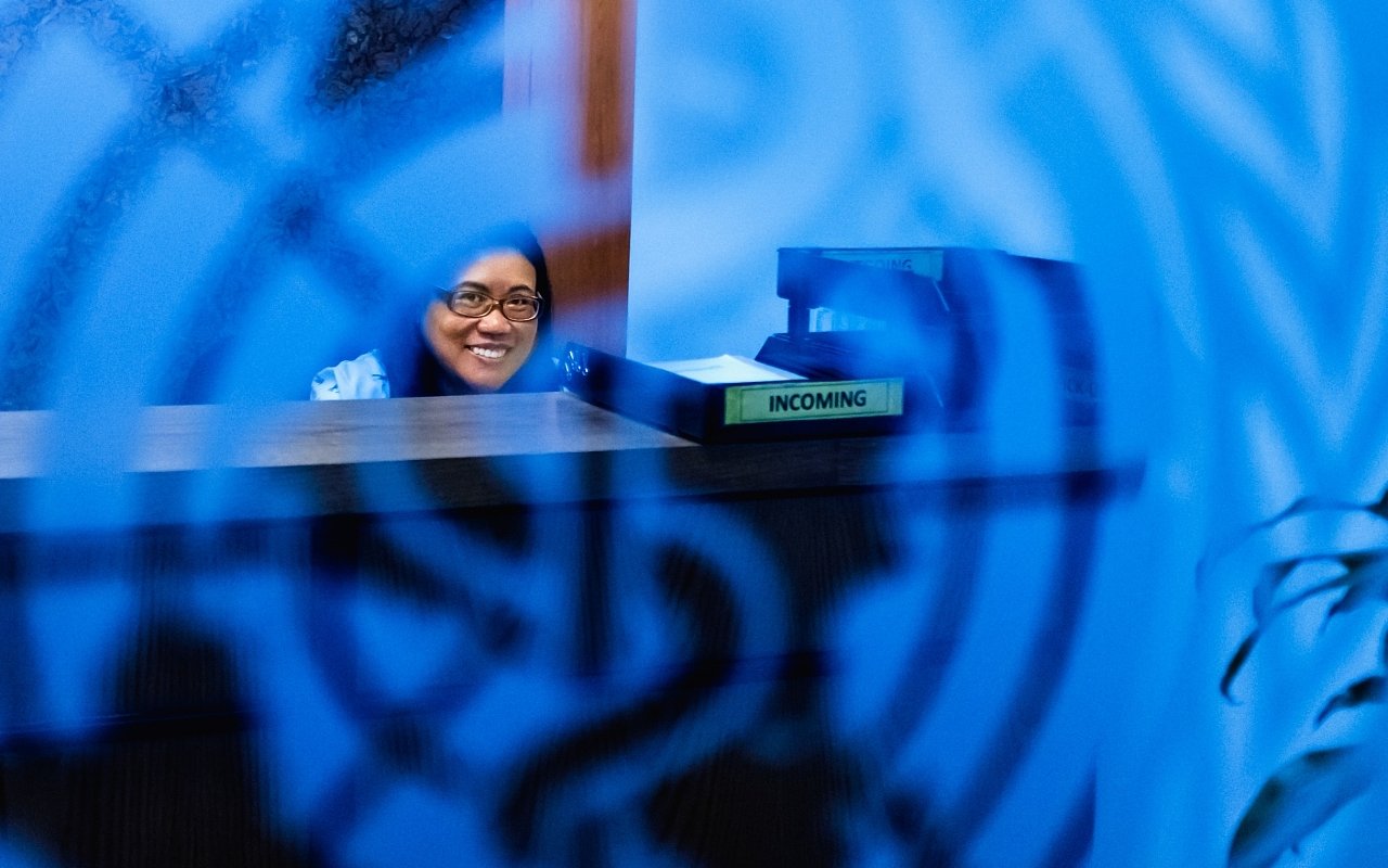 Front desk WHO staff sitting behind a desk.