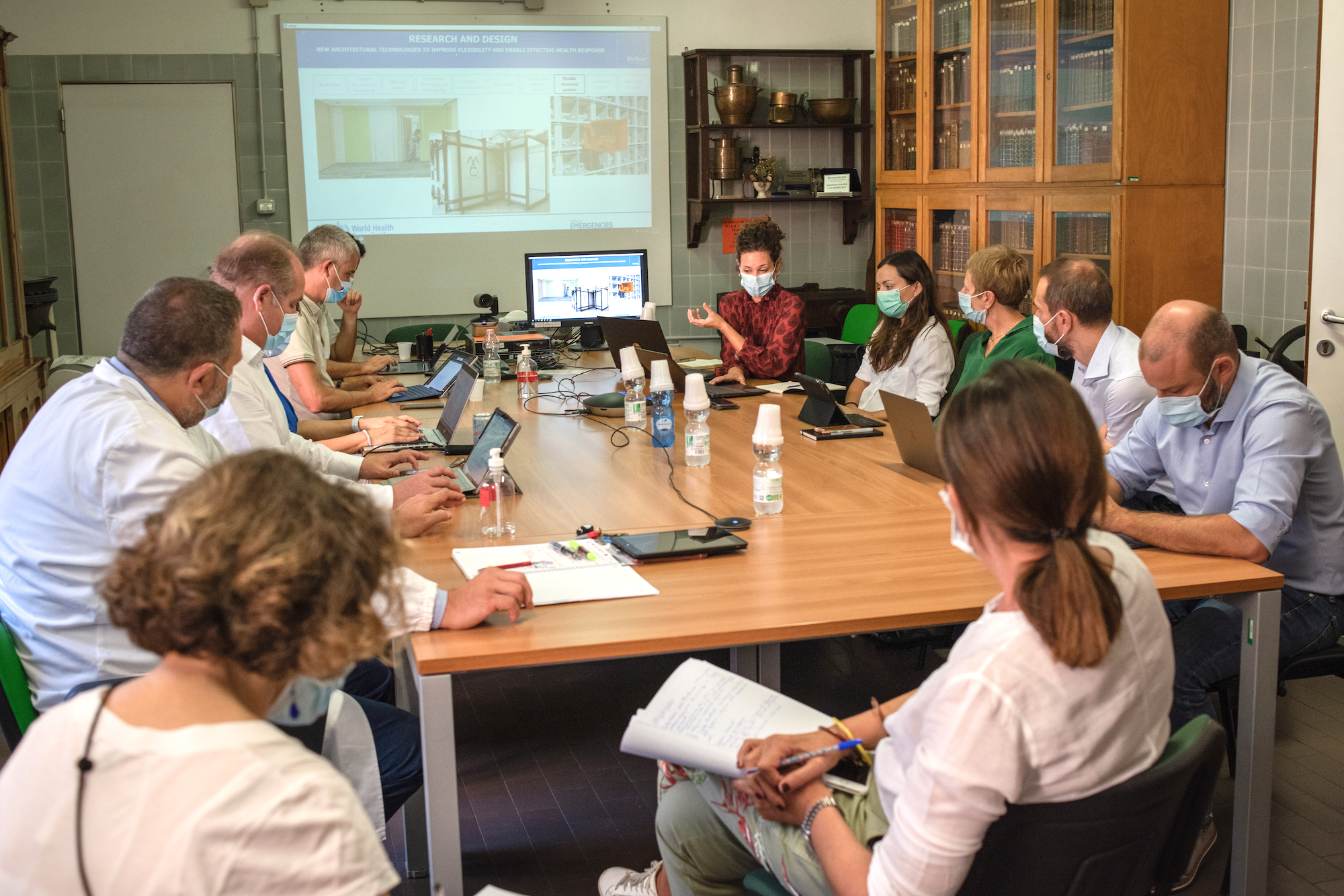 prepare-for-surges 17 September 2020: Architect and WHO Consultant Anna Silenzi (centre, wearing red) and Engineer and WHO Hospital Readiness Consultant Anja Borojevic (sitting to Anna’s left) give a presentation during a meeting about “hospitals of the future.”