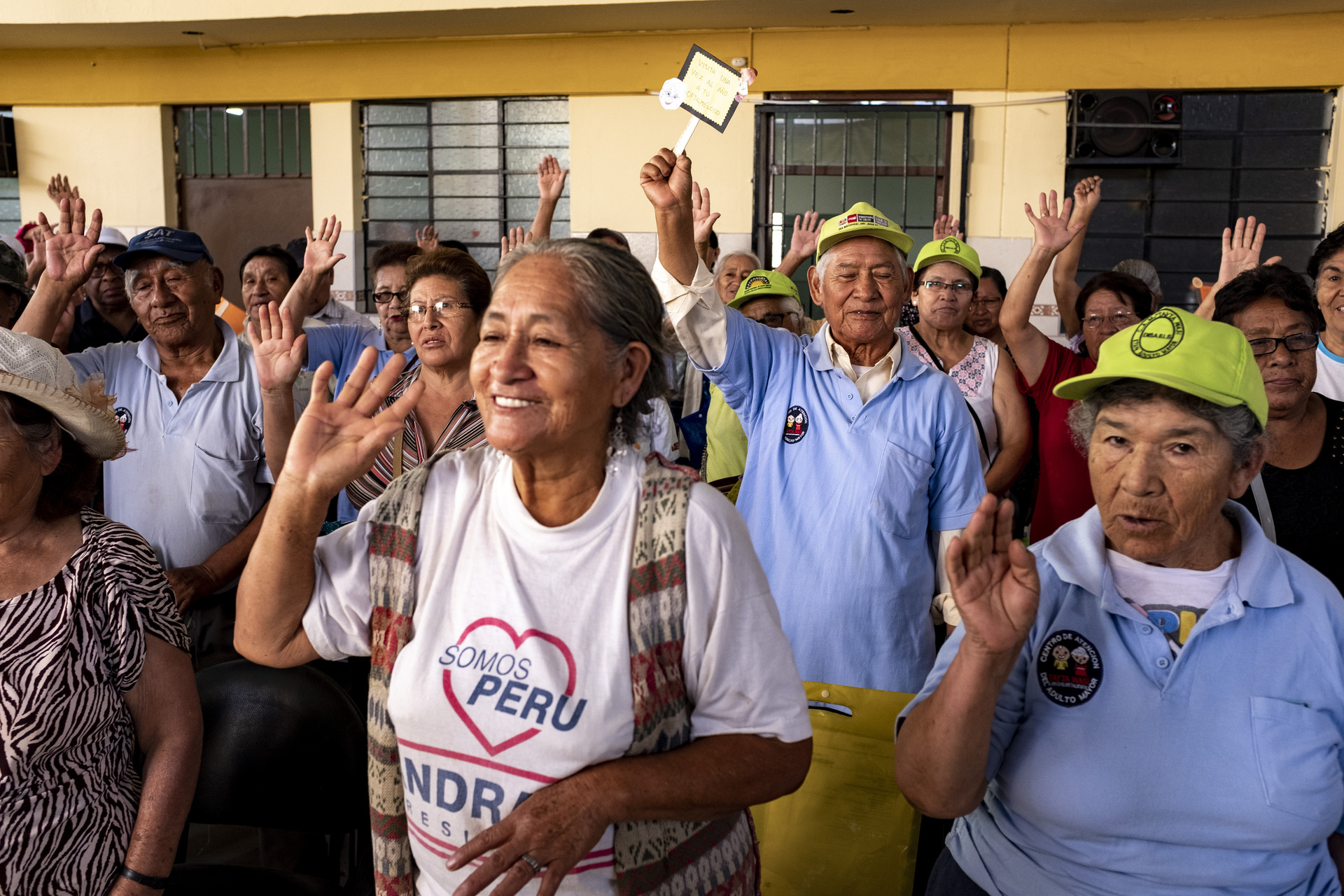 005_WHO Peru A group of older people raising their hands