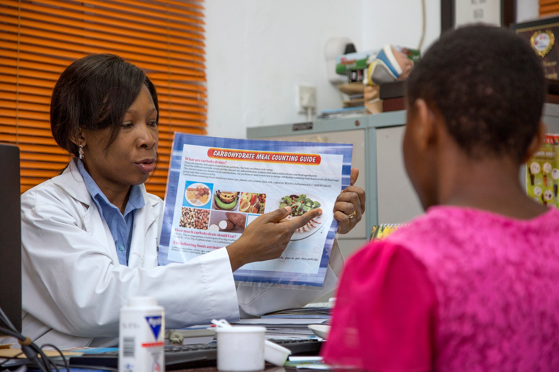 who-060984 A doctor showing a patient an image