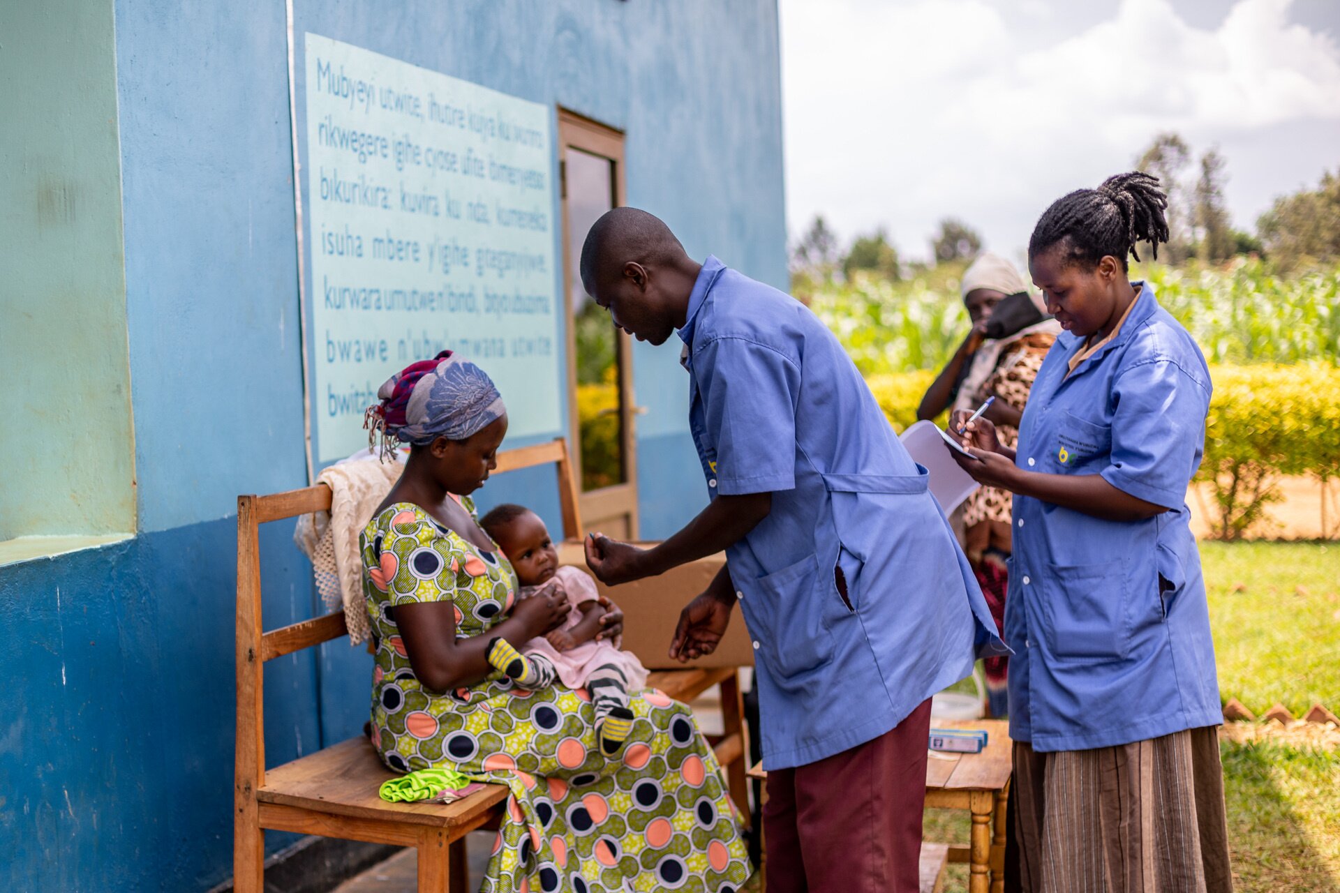 Maternal and child health campaign services Two health care workers are attending to a mother holding her baby.