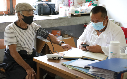 Doctor monitoring blood pressure - SCCI programme at the Samadingkha PHC-Bhutan