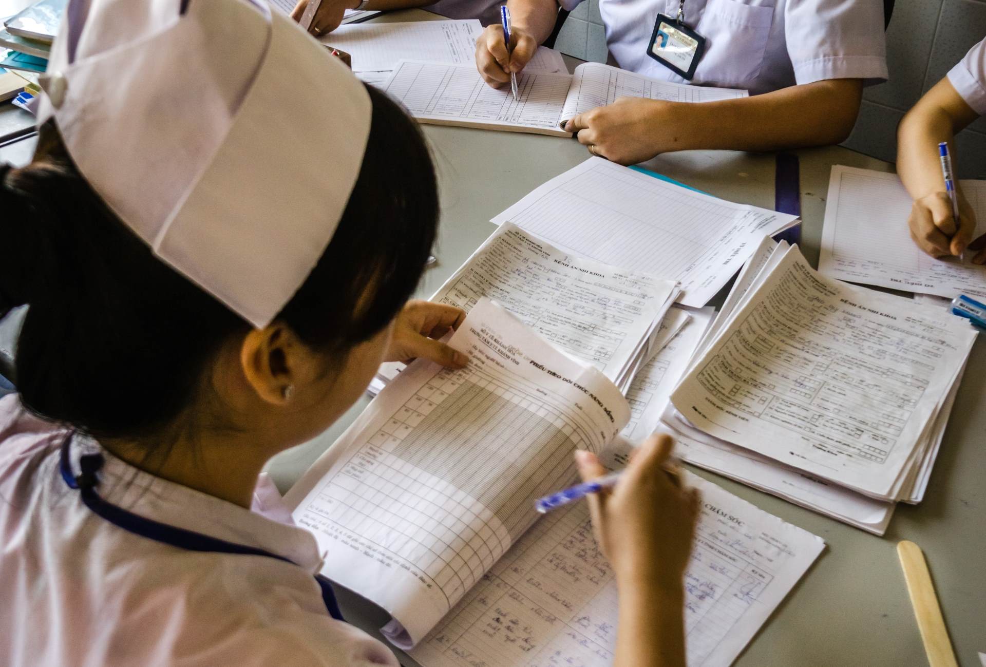 WP2843 A nurse looks at some health data and completes tables.